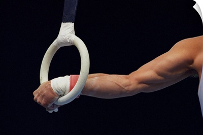 Detail of the hands of male gymnast grabbing the ring