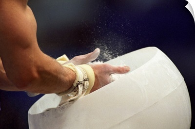 Detail of the hands of male gymnast preparing for competition