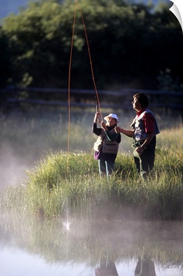 Father fly fishing with his daughter