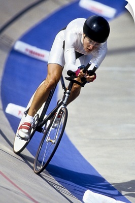 Female cyclist racing on the velodrome track