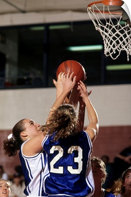 Female High School basketball players in action during a game