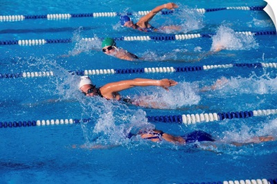 Female swimmers competing in a freestyle race