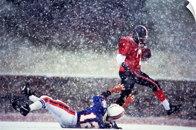 Football players in action during snowy game