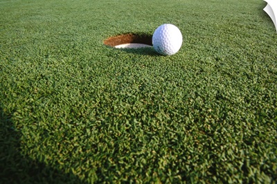 Golf ball at the hole