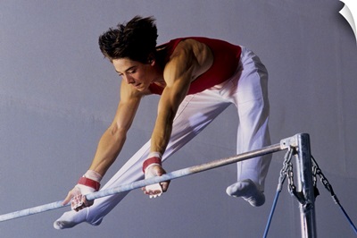 Male gymnast performing on the horizontal bar