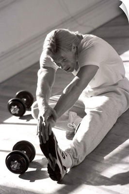 Man stretching in gym