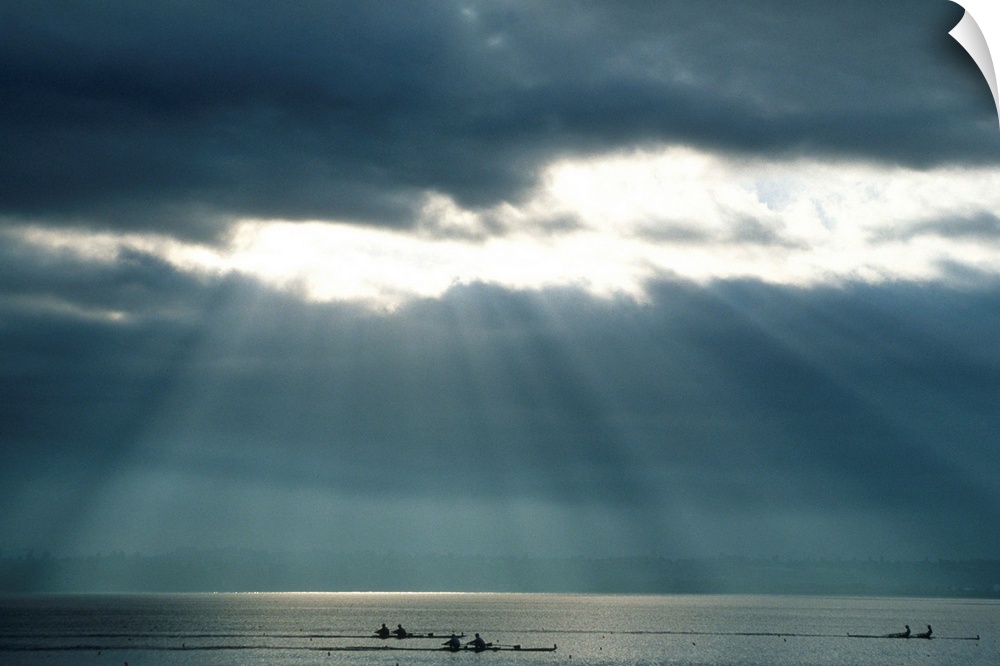 Rowing teams silhouetted on a lake