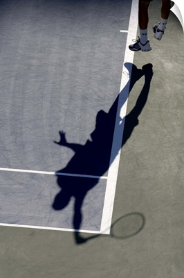 Shadow of tennis player serving