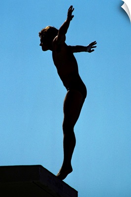 Silhouette of male diver about to dive off the 10m platform