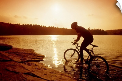 Silhouette of mountain biker at sunset