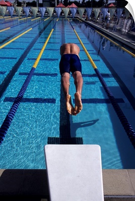 Swimmer diving off the starting blocks to begin a race