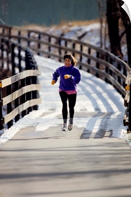 Woman out for a fitness run in winter
