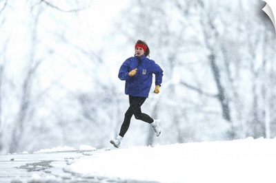 Woman running outdoors in snowy weather