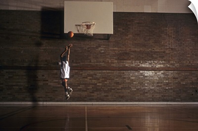 Young boy practicing his basketball shooting