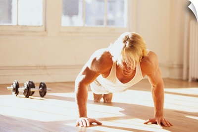 Young man performing push up exercise in gym