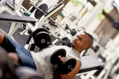 Young man working out with hand weights