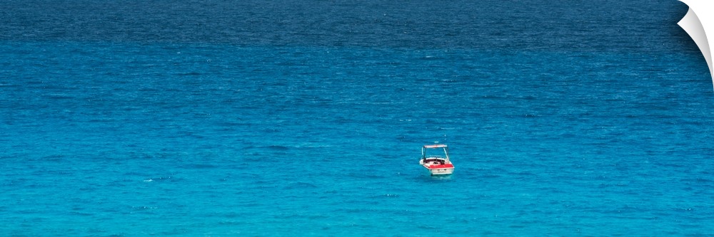 Panoramic photograph of a single boat floating in the bright blue ocean. From the Viva Mexico Panoramic Collection.