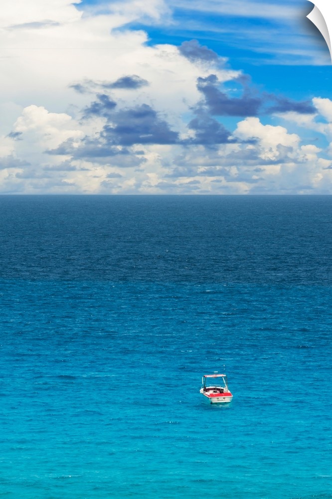 Photograph of a single boat on the clear blue sea. From the Viva Mexico Collection.