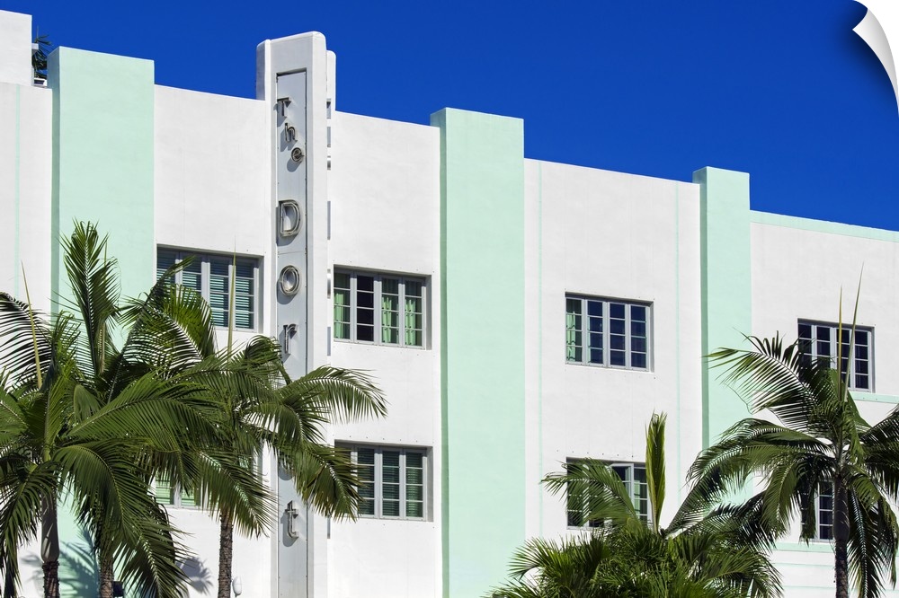 Palm trees frame an Art Deco style building in Miami, Florida.