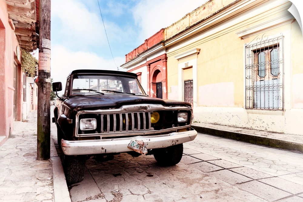 Washed out photograph of an old black Jeep parked on the side of a colorful street in Mexico. From the Viva Mexico Collect...