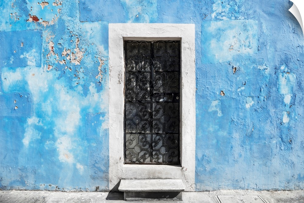Photograph of a blue exterior wall with a white doorway in Mexico. From the Viva Mexico Collection.