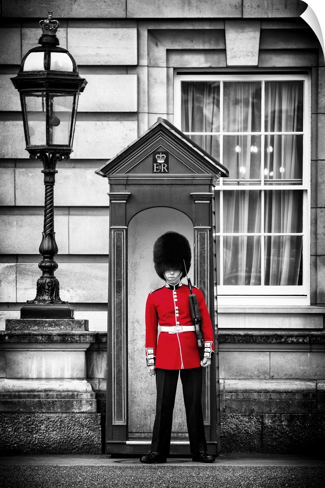 Photo with selective color of a guard in traditional uniform at Buckingham Palace in London, England.