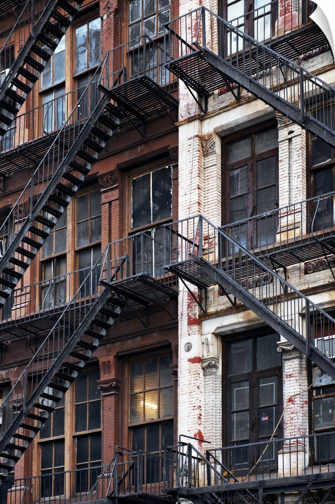 Criss-crossing fire escapes create an abstract image on the sides of a New York building.