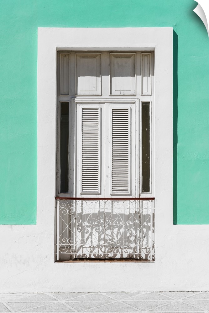 Photograph of a coral green and white facade with a window in Havana.