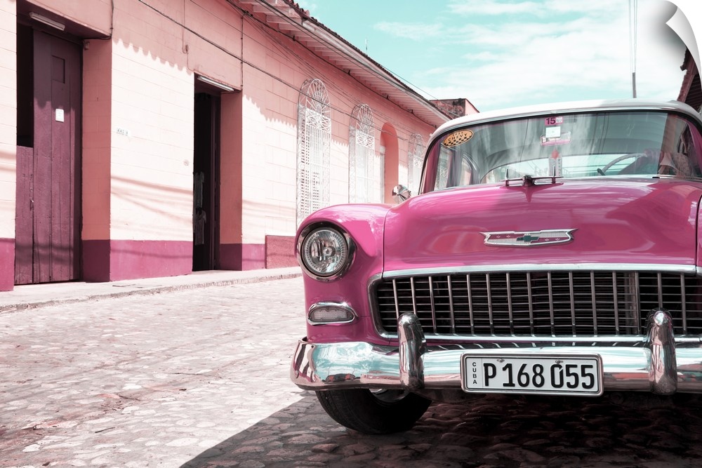 Photograph of the front of a pink vintage Chevy parked on the side of a road.