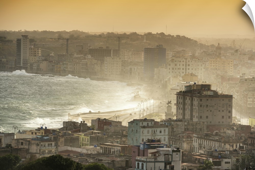 Aerial photograph of the ocean meeting the city of Havana at sunrise.
