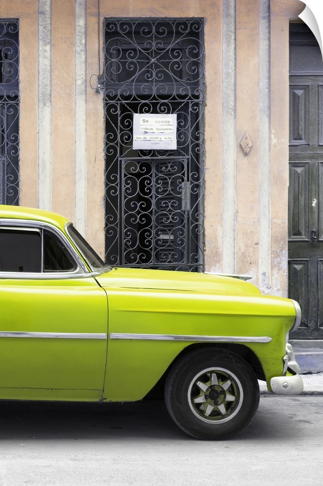 Photograph of a lime green vintage car parked outside in the streets of Havana.