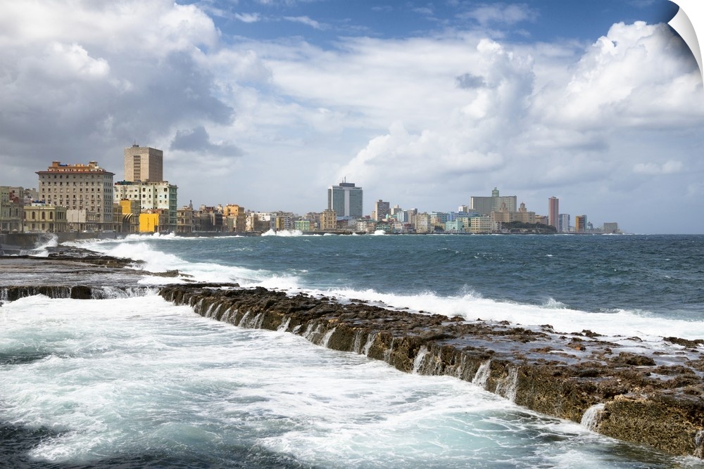 Photograph of Malecon seawall with the city of Havana in the background.