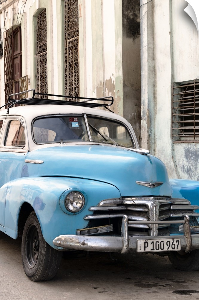Photograph of a blue vintage Chevrolet parked outside in the streets of Havana.