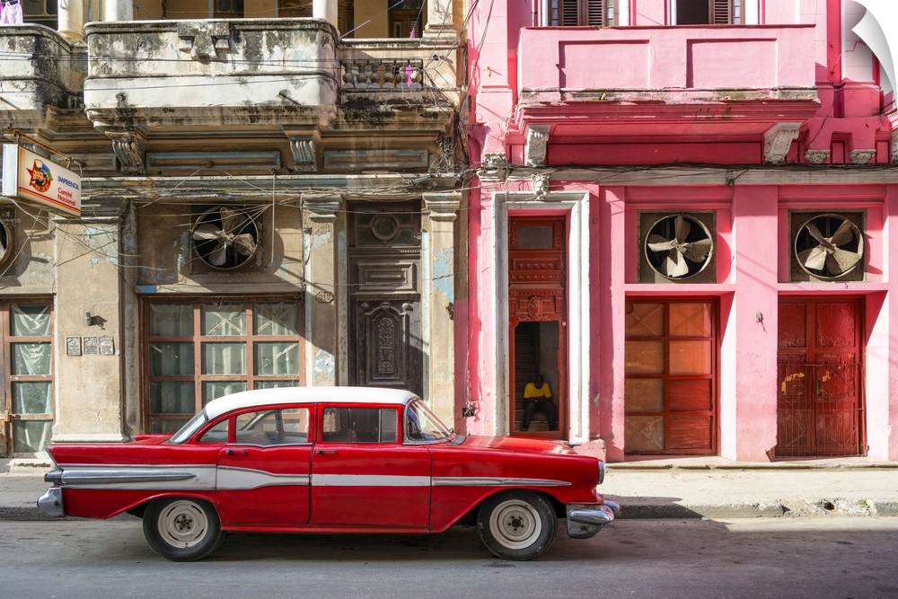 Photograph of a red vintage car with white details parked in the street, Havana, Cuba