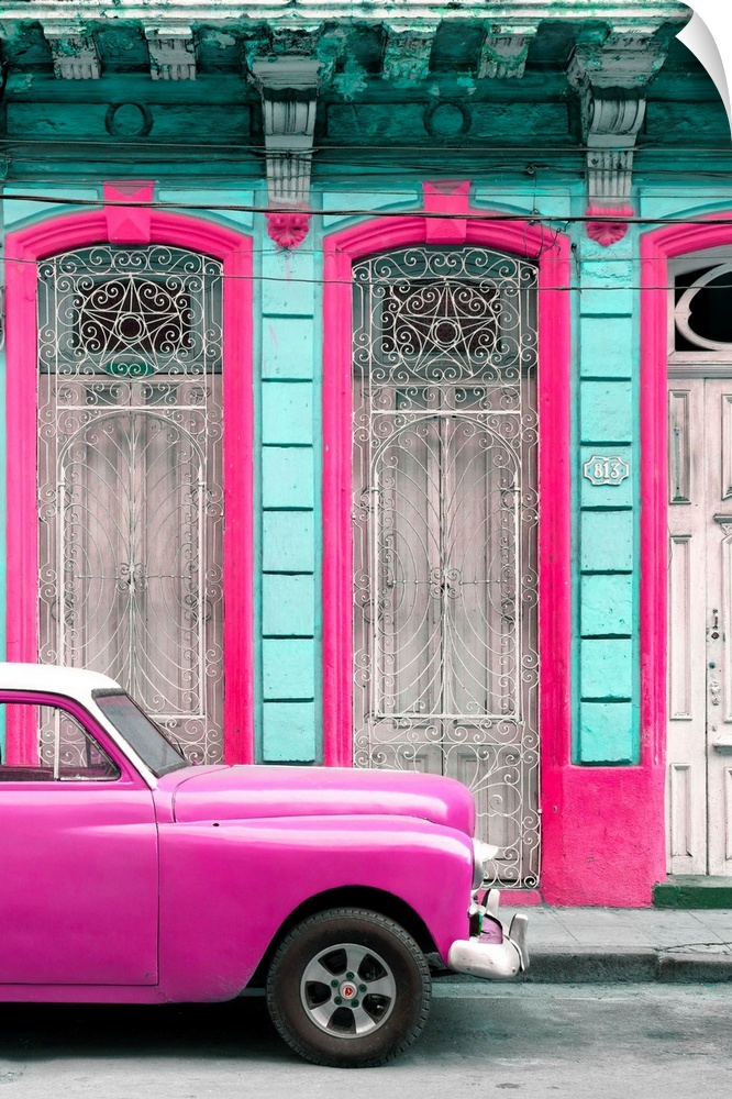 Photograph of a bright pink vintage car parked outside of a beautiful old building with a bright pink and light blue facade.