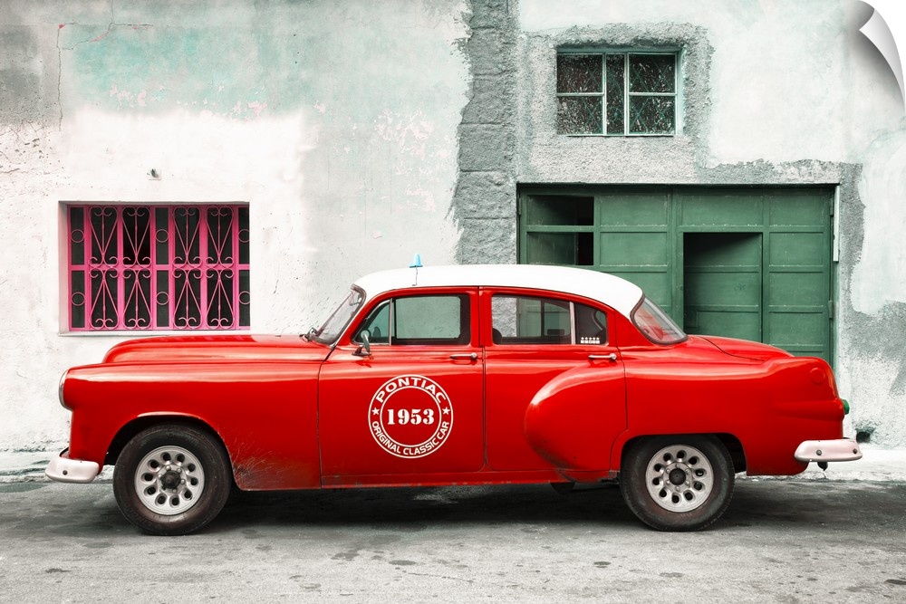 Photograph of a vintage red Pontiac Original Classic Car from 1953 parked on the streets of Havana.