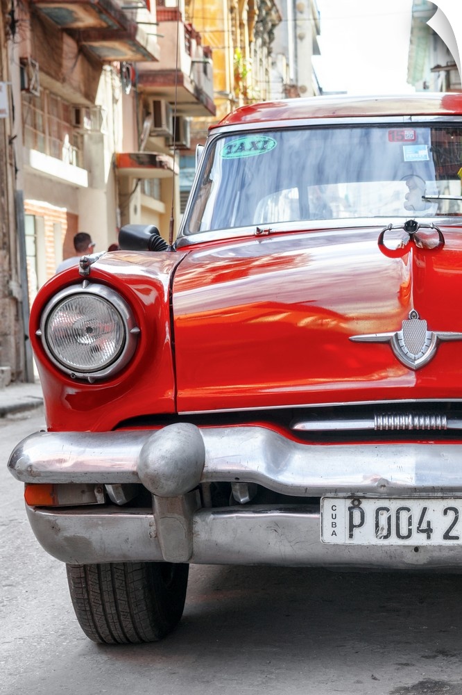 Photograph of the front of a bright red taxi cab in Havana.