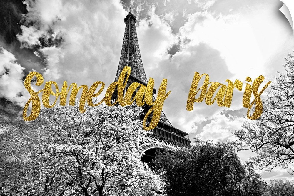 Black and white photograph of the Eiffel Tower surrounded by treetops with the phrase "Someday Paris" written on top in go...