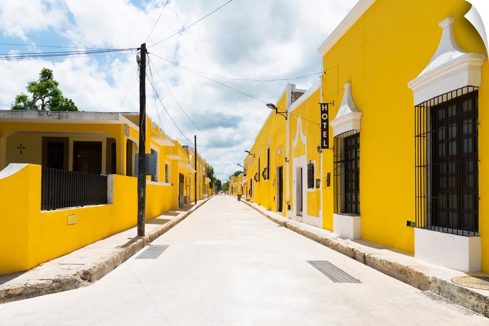 Street view photograph highlighting the yellow buildings in Izamal, Yucat?n, Mexico. From the Viva Mexico Collection.�