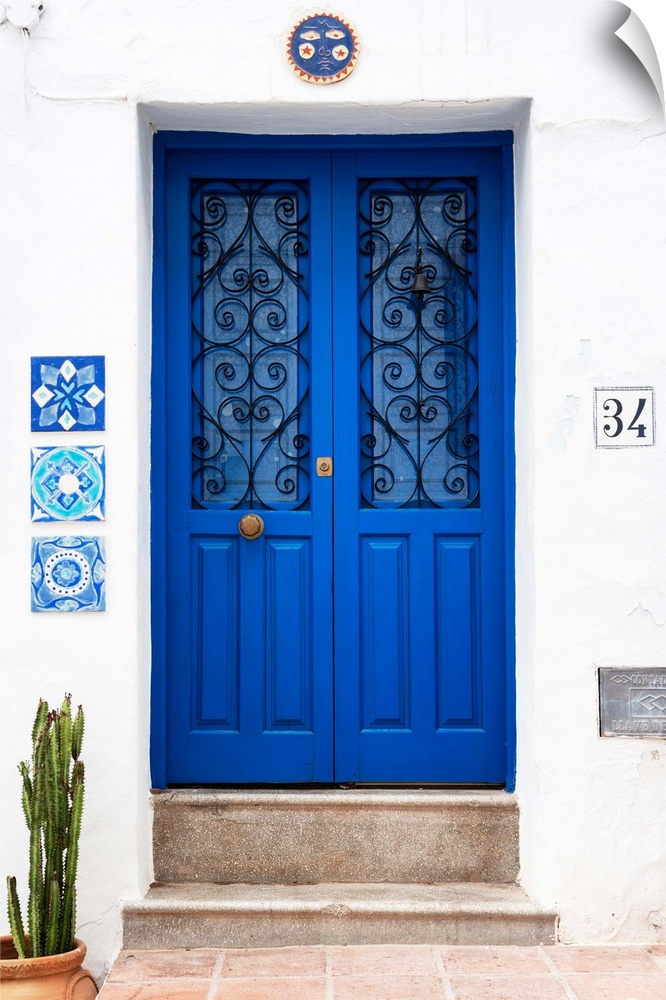 It's an old blue door on a white wall in Mijas, Spain.
