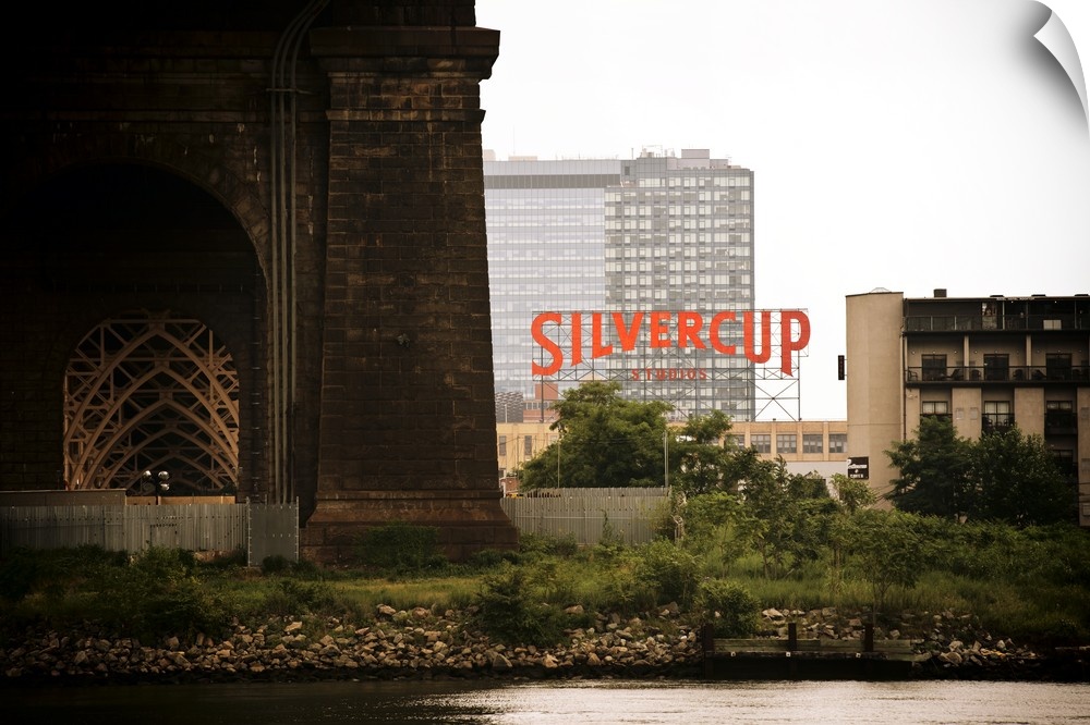 Photograph of the large Silvercup sign between large buildings in New York.