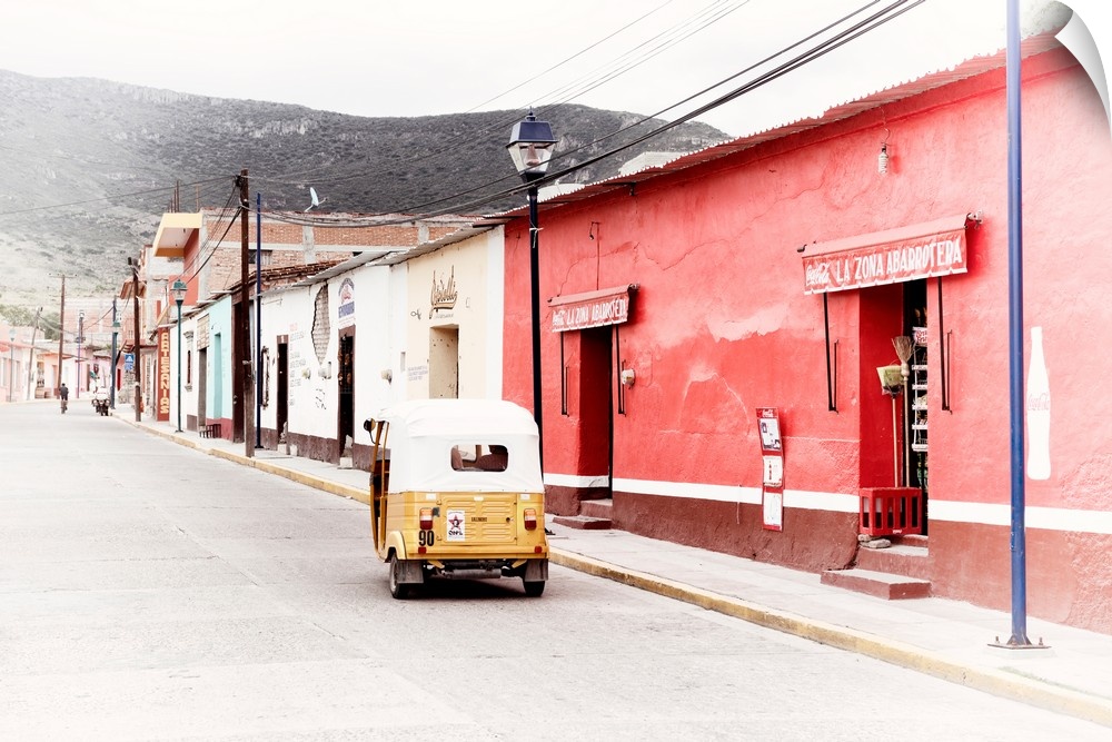 Washed out photograph of a Mexican street scene with a yellow Tuk Tuk on the road. From the Viva Mexico Collection.