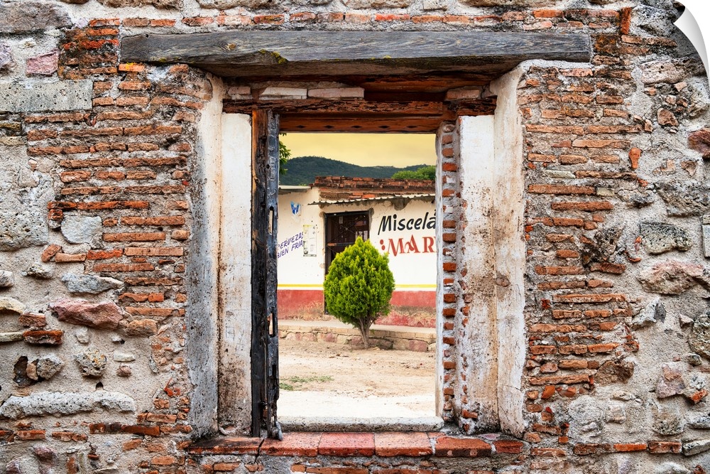 View of a Mexican village framed through a stony, brick window. From the Viva Mexico Window View.