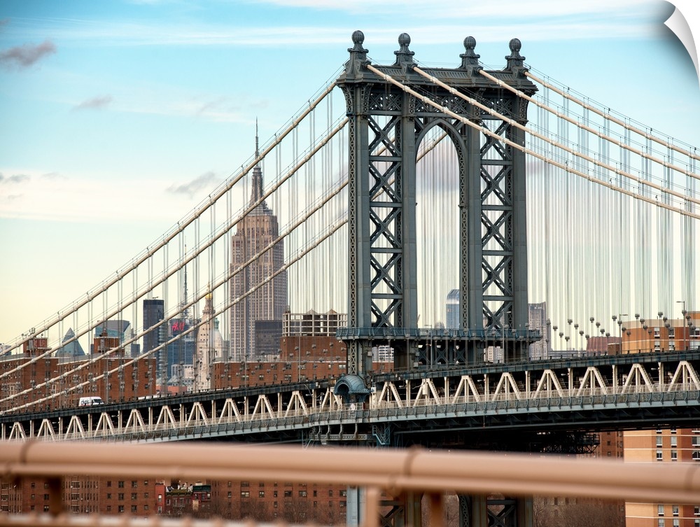 A photograph of the Manhattan bridge, with the Empire state building in the background.