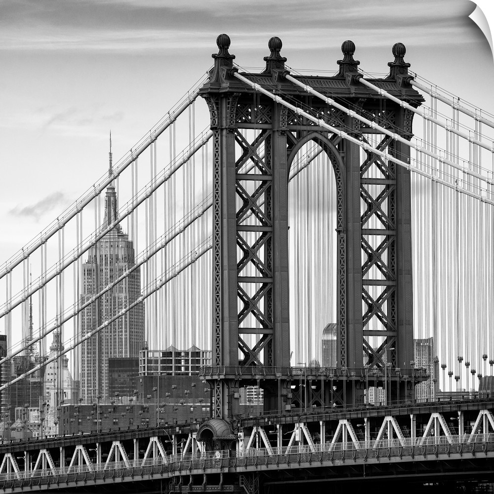 A black and white photograph of the Manhattan bridge, with the Empire state building in the background.