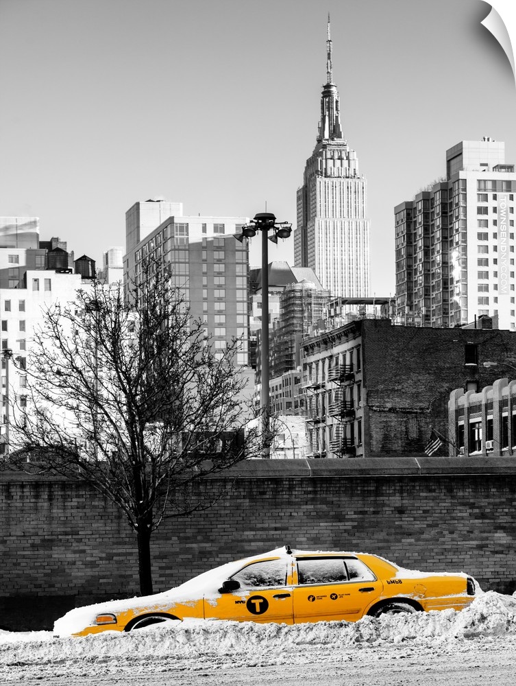 A photograph of a yellow taxi cab in Manhattan in winter.