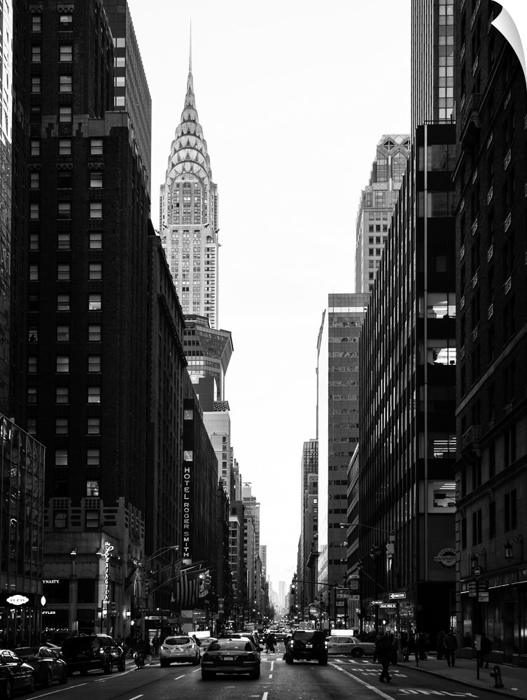 A fine art photograph looking down a road in New York city with the Chrysler building sticking up above the rest of the bu...