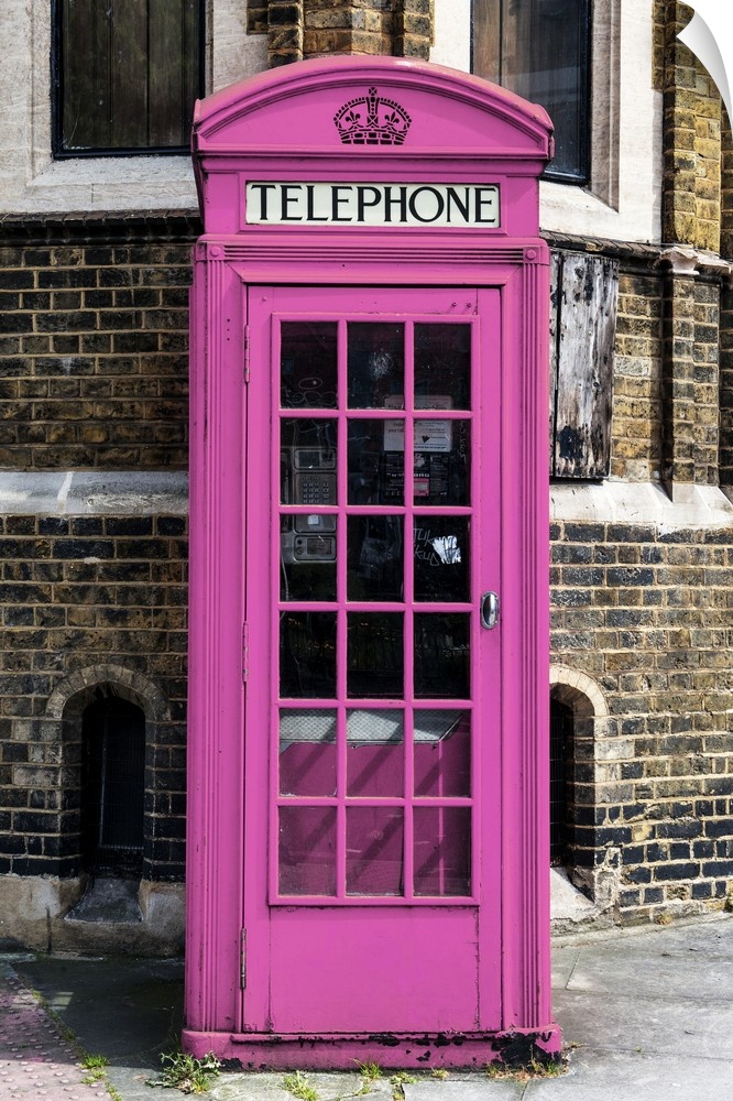 Fine art photo of an iconic telephone booth, painted unusually pink, on a London street corner.