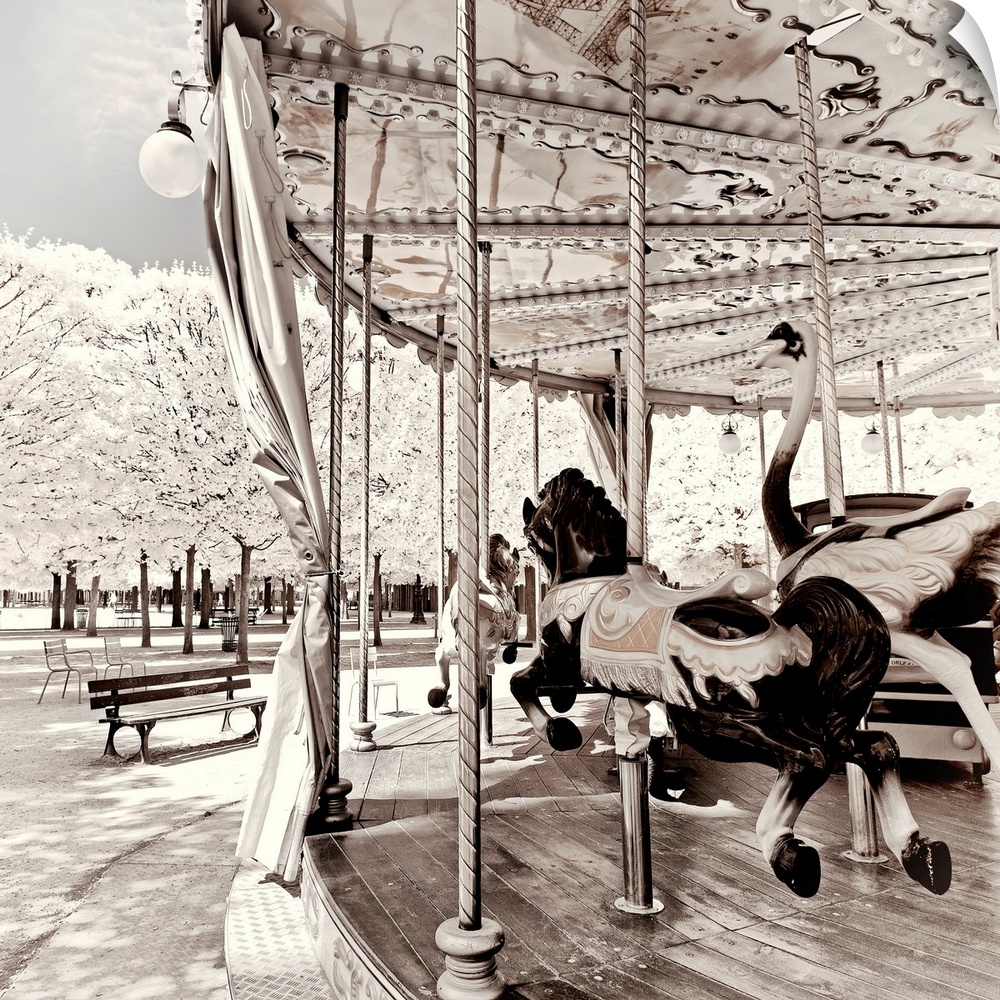 It's a winter landscape with a Parisian carousel in the Tuileries Garden in Paris. The trees have white leaves frosted by ...