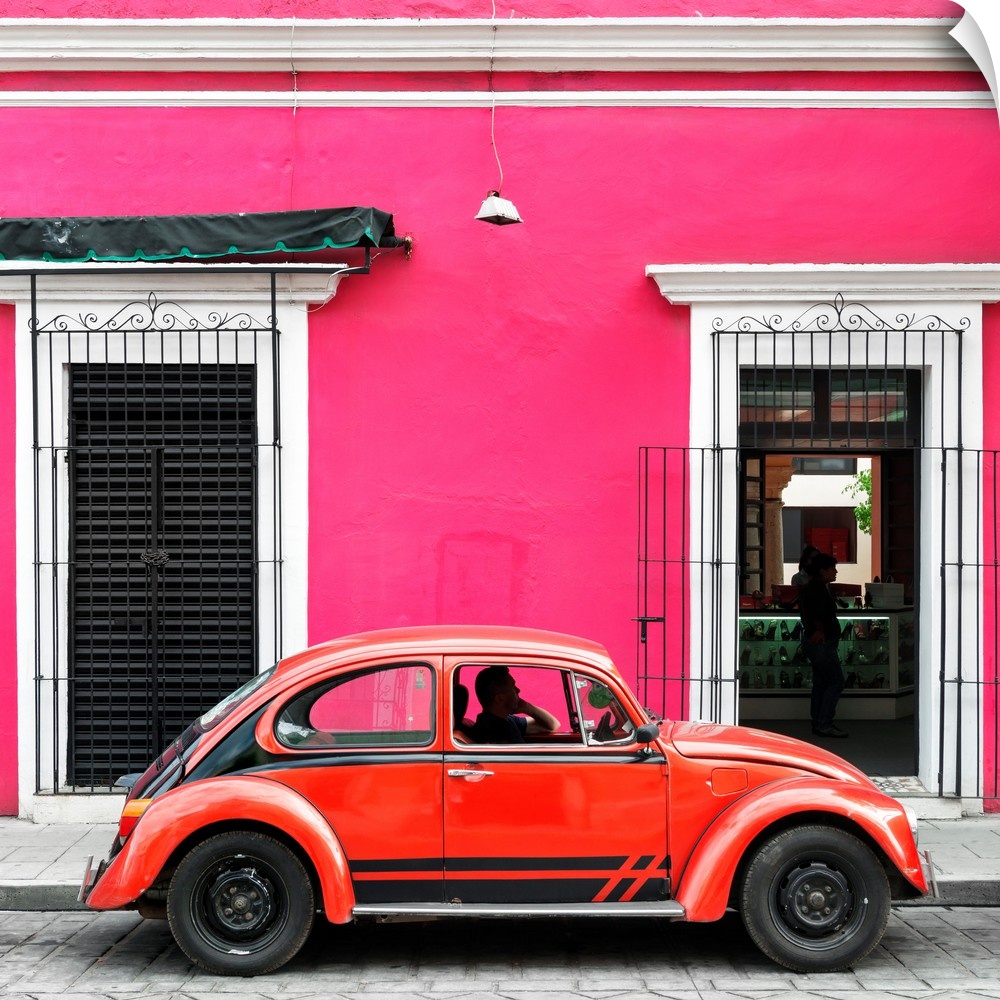 Square photograph of a classic red Volkswagen Beetle parked in front of a pink building. From the Viva Mexico Square Colle...